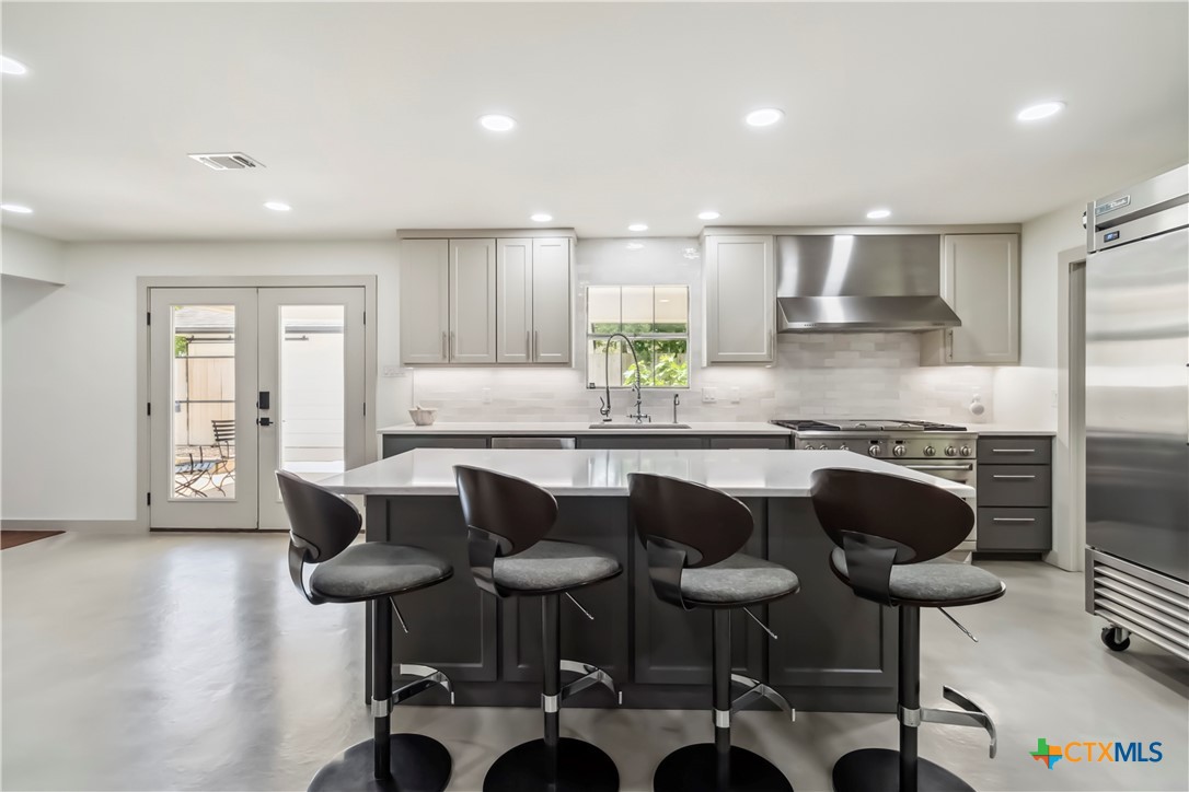 425 West Edgewater Terrace New Braunfels, TX 78130 - Photo 4 of 45 a kitchen with a table chairs stove and cabinets