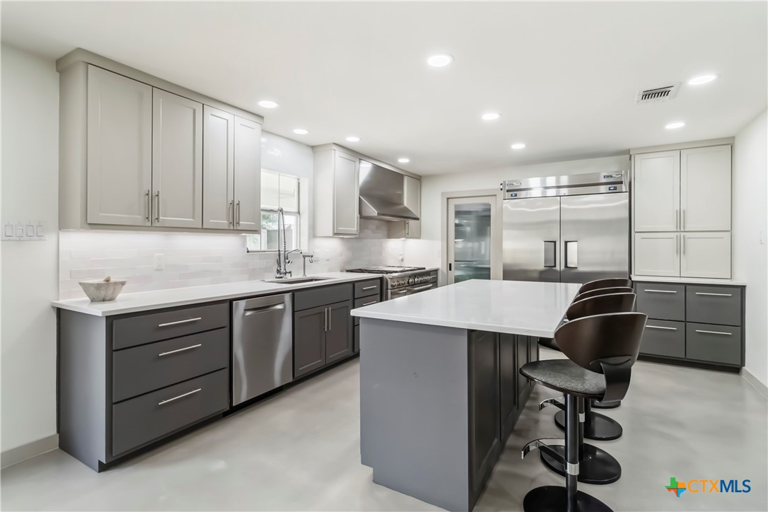 425 West Edgewater Terrace New Braunfels, TX 78130 - Photo 5 of 45 a kitchen with kitchen island cabinets and refrigerator