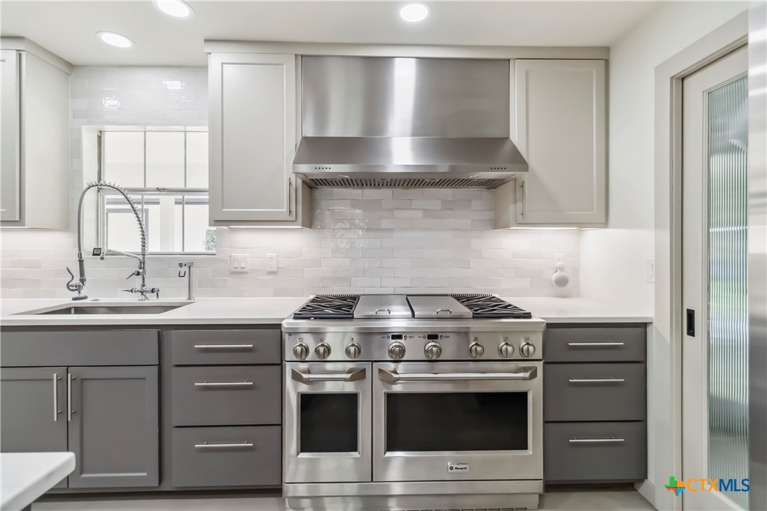 425 West Edgewater Terrace New Braunfels, TX 78130 - Photo 9 of 45 a kitchen with a stove and a sink