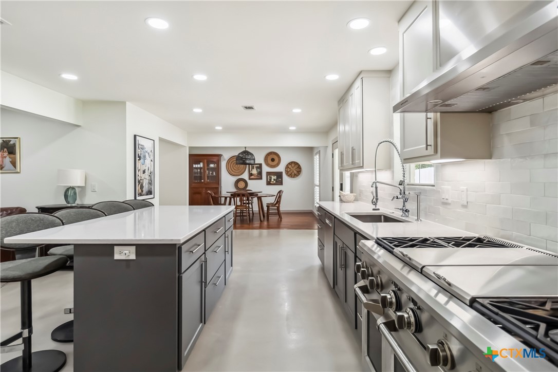 425 West Edgewater Terrace New Braunfels, TX 78130 - Photo 10 of 45 a kitchen with kitchen island a sink stove and cabinets