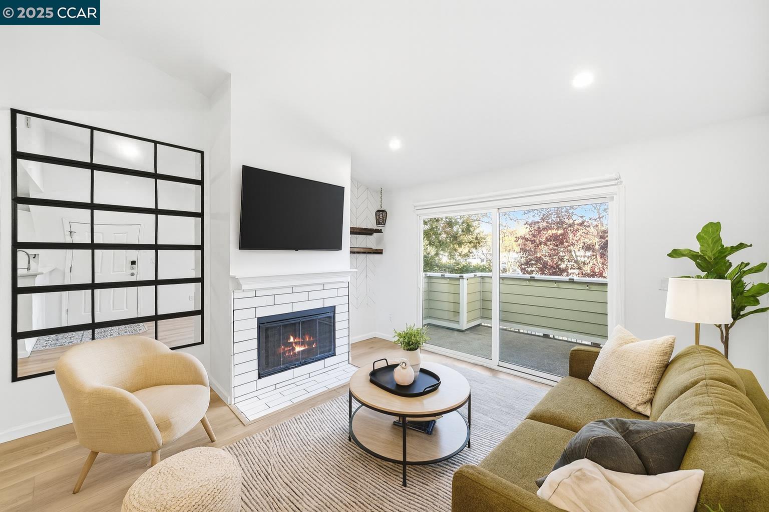 a living room with furniture a fireplace and a flat screen tv