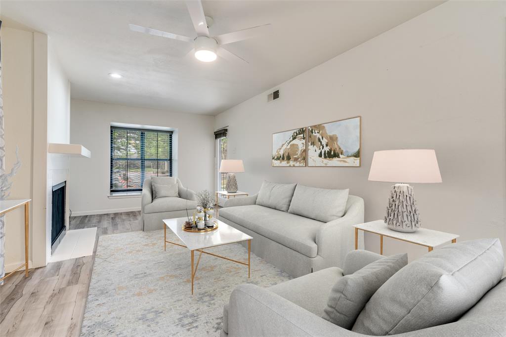 a living room with furniture a flat screen tv and a large window