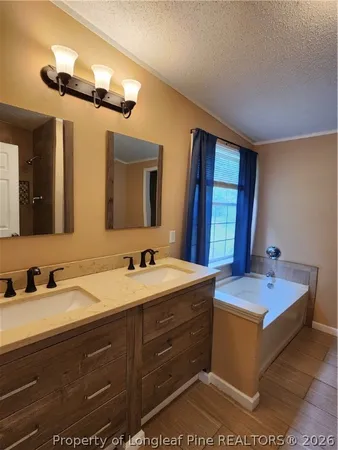 a bathroom with a granite countertop sink a large mirror and a bathtub