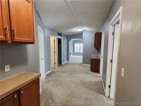 a view of a kitchen with furniture and a hallway