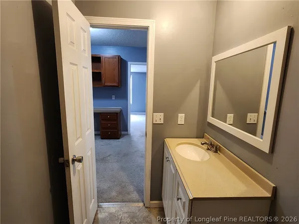 a bathroom with a sink a toilet and mirror