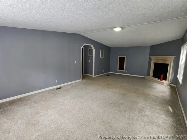 a view of an empty room with a fireplace