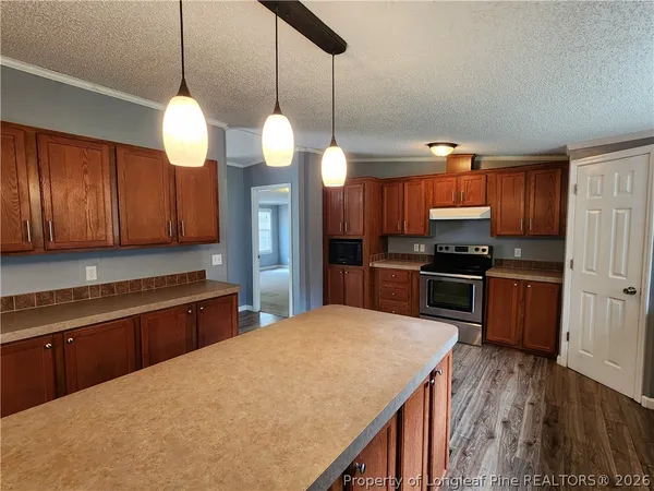 a kitchen with stainless steel appliances a stove a refrigerator and a sink
