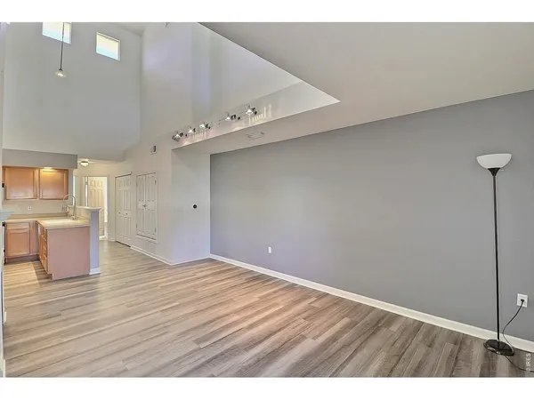 a view of an empty room with wooden floor