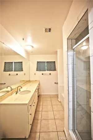 a view of a large white house with a large window and plants