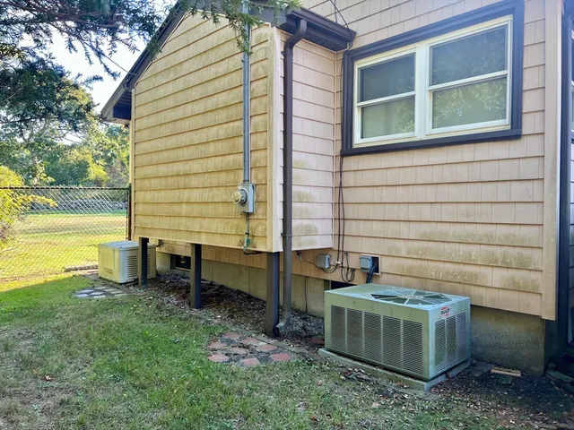 a front view of a house with a yard table and chairs