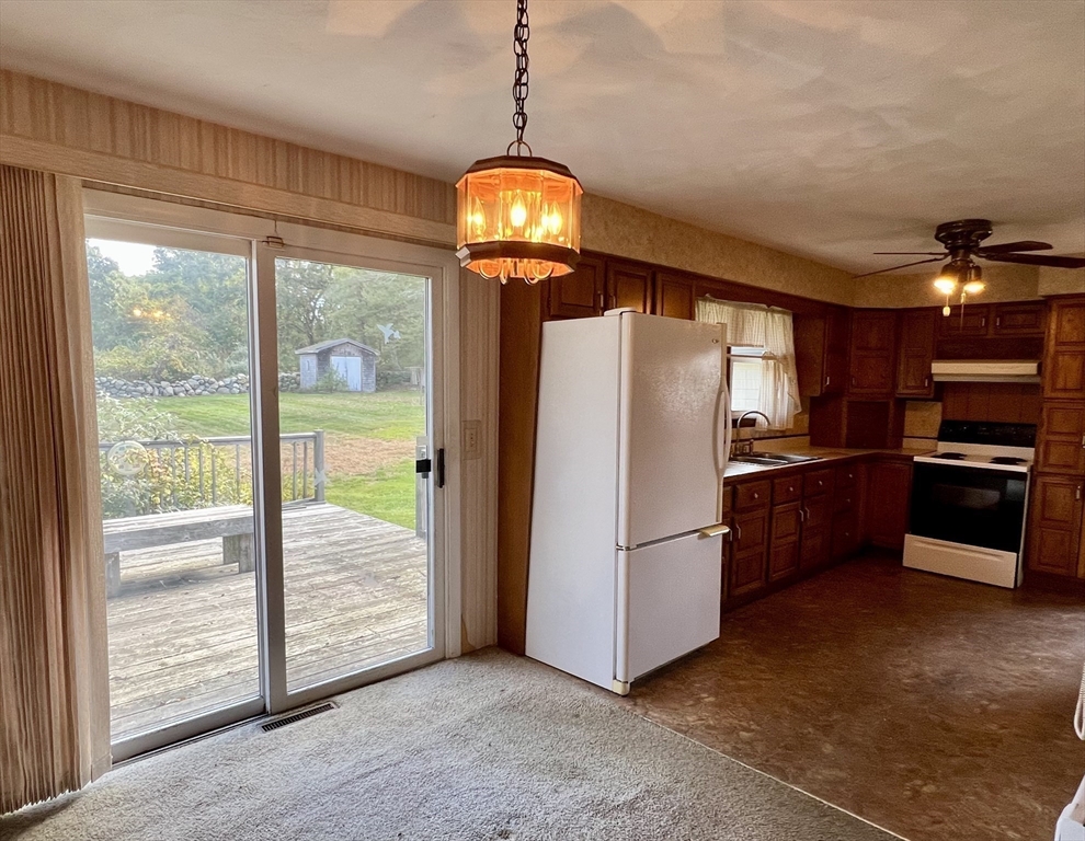 1580 Main Road Westport, MA 02790 - Photo 14 of 26 a kitchen with refrigerator a microwave and a sink