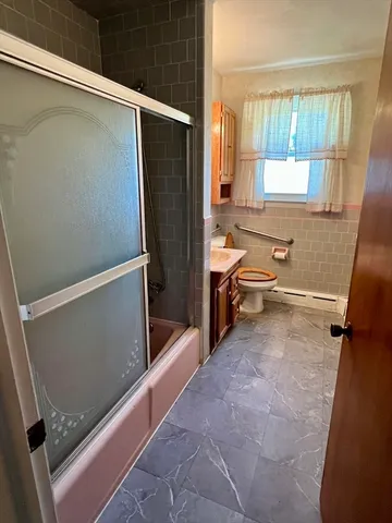 a bathroom with a toilet a sink and a mirror