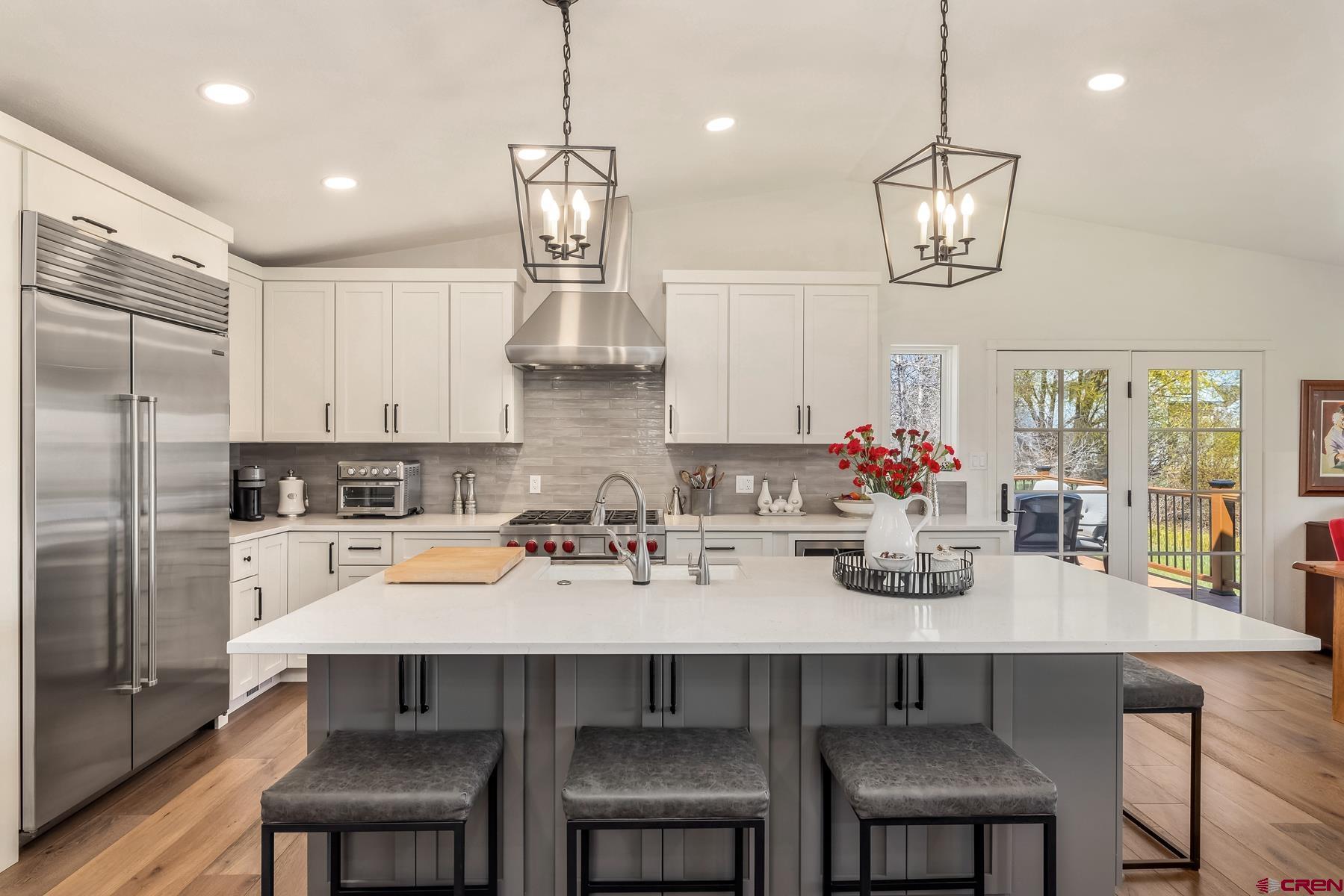 389 Apache Road Gunnison, CO 81230 - Photo 12 of 43 a kitchen with a dining table chairs and refrigerator