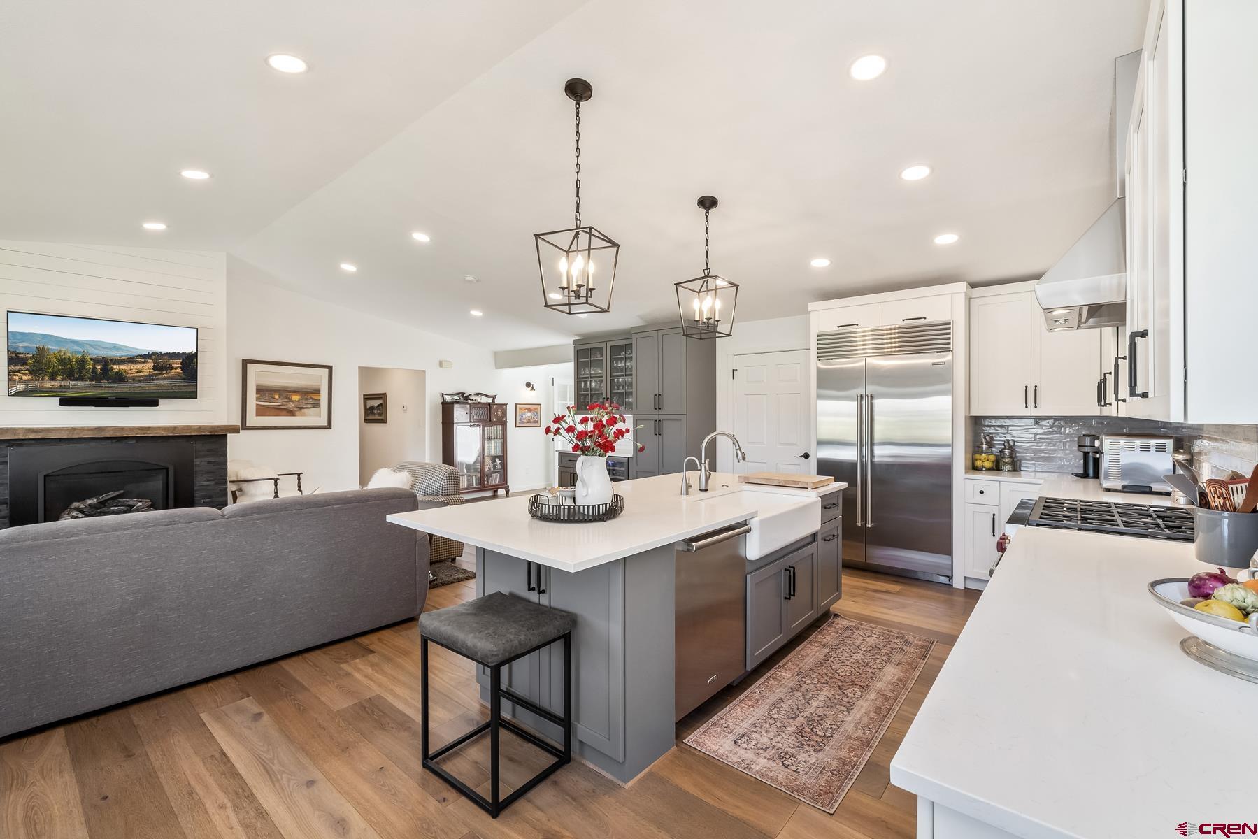 389 Apache Road Gunnison, CO 81230 - Photo 15 of 43 a kitchen with stainless steel appliances kitchen island granite countertop a sink and cabinets