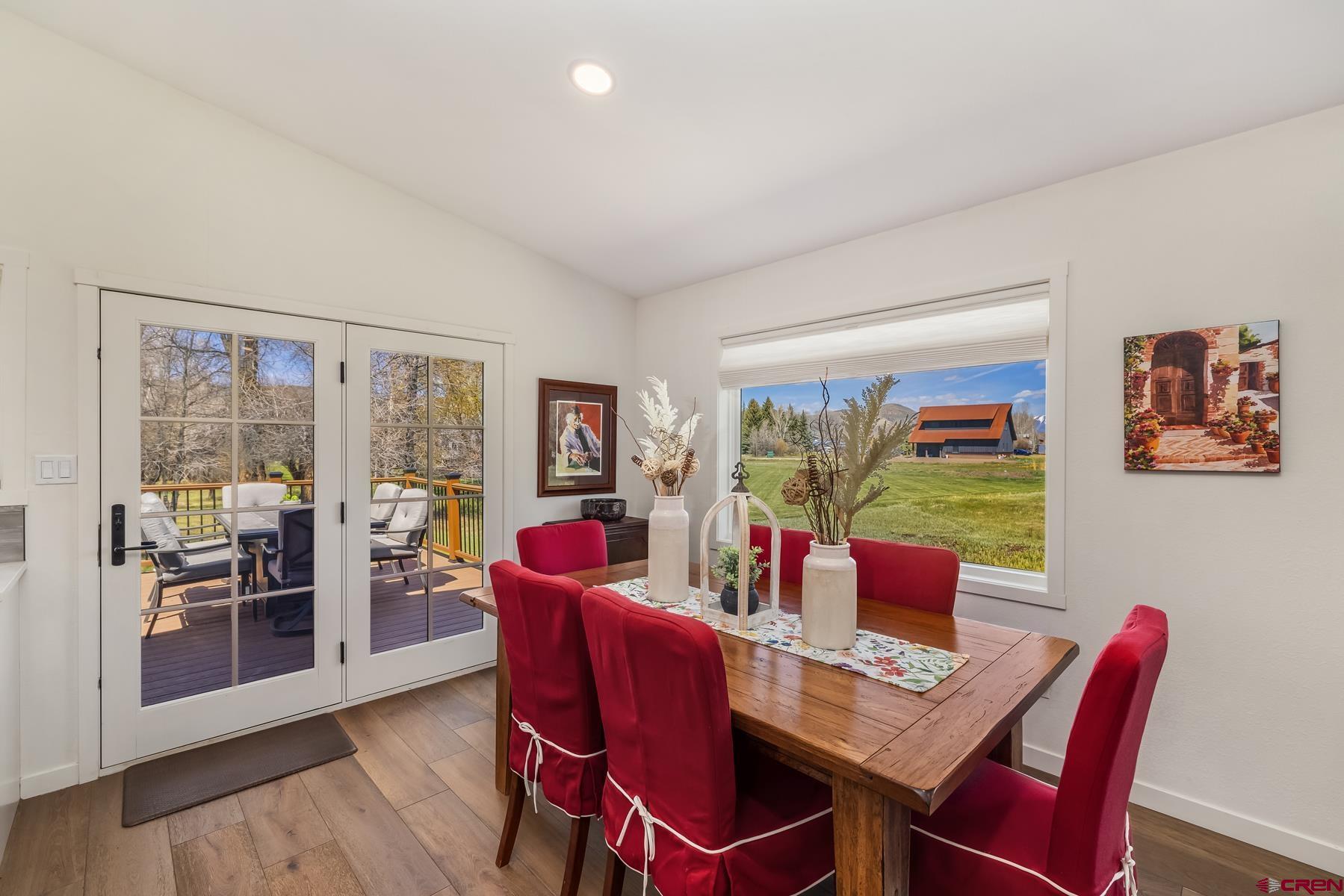 389 Apache Road Gunnison, CO 81230 - Photo 19 of 43 a view of a dining room with furniture window and wooden floor