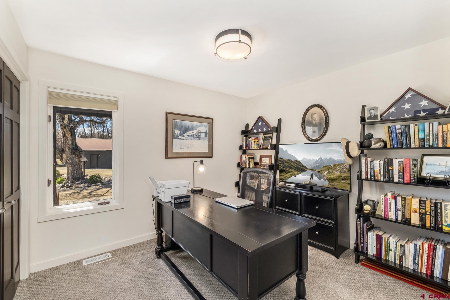 389 Apache Road Gunnison, CO 81230 - Photo 28 of 43 a view of a workspace with furniture and a bookshelf