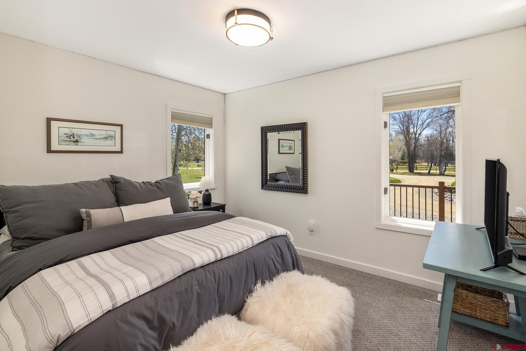 389 Apache Road Gunnison, CO 81230 - Photo 29 of 43 a bedroom with a bed a couch and a window