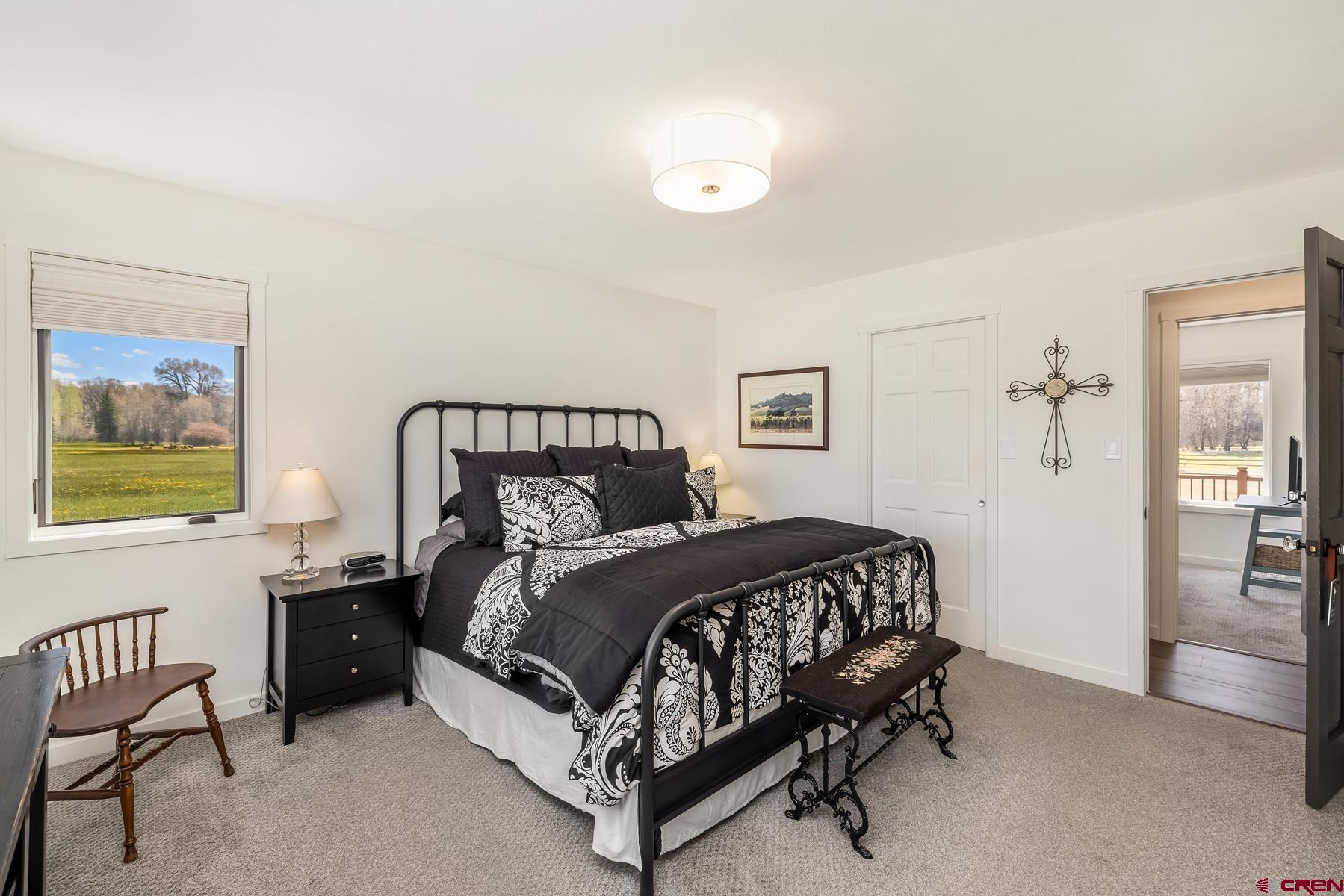 389 Apache Road Gunnison, CO 81230 - Photo 31 of 43 a bed sitting in a bedroom next to a window