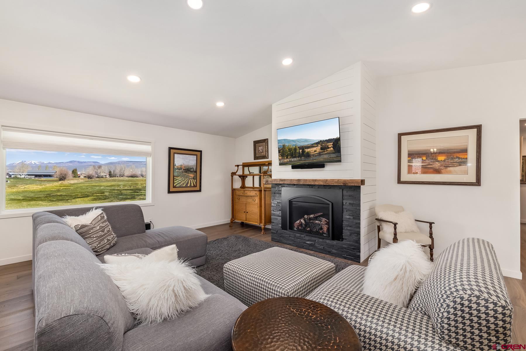 389 Apache Road Gunnison, CO 81230 - Photo 7 of 43 a living room with furniture fireplace and a flat screen tv