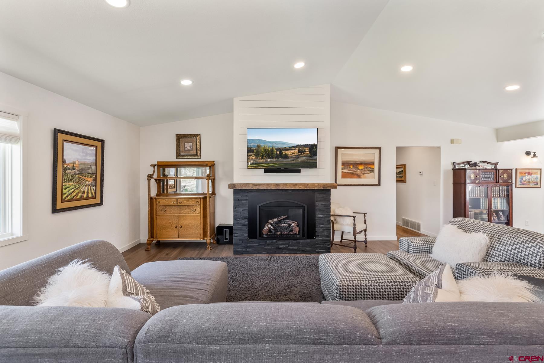 389 Apache Road Gunnison, CO 81230 - Photo 8 of 43 a living room with furniture and a fireplace