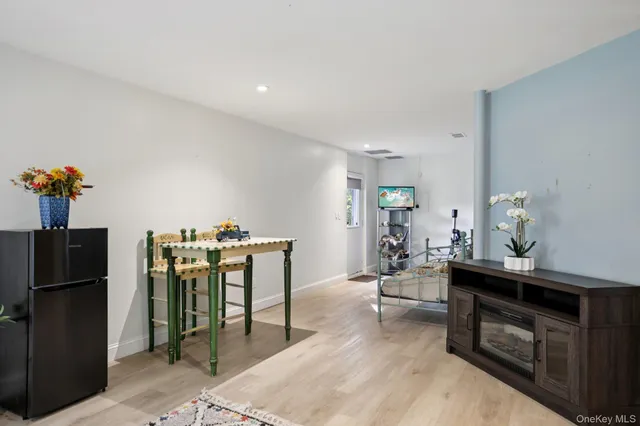 a living room with furniture a flowers and a fireplace