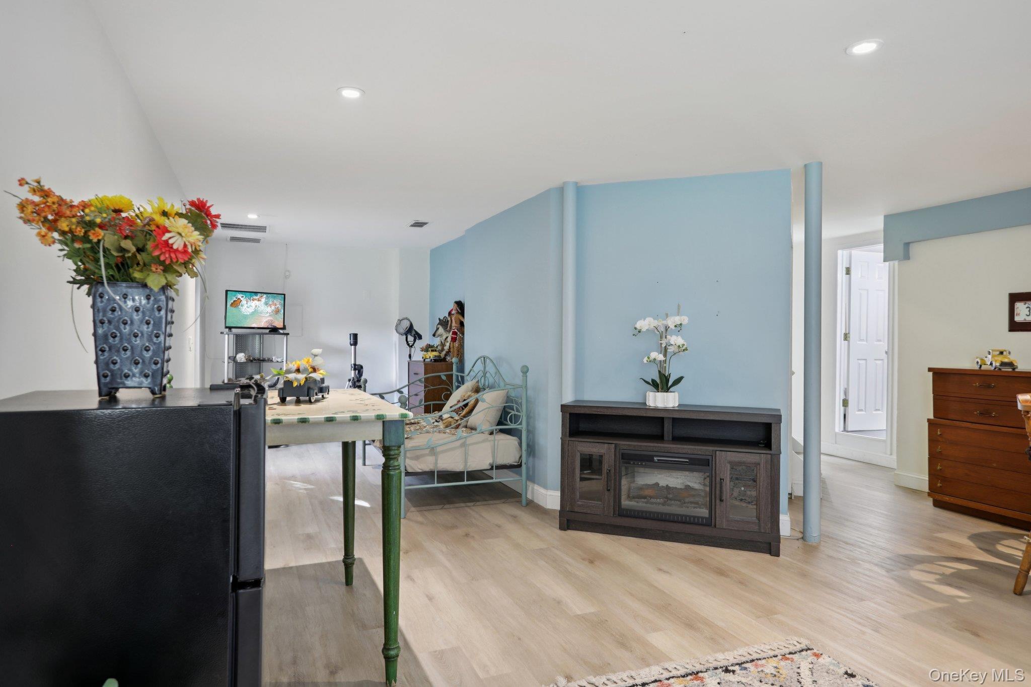 30 Reed Court Washingtonville, NY 10992 - Photo 24 of 36 a living room with furniture a flowers and a fireplace