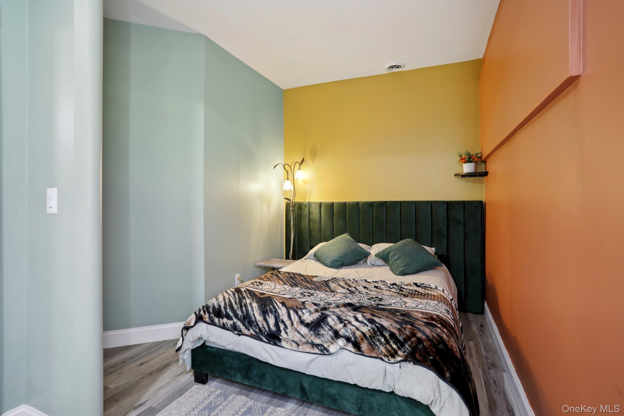 30 Reed Court Washingtonville, NY 10992 - Photo 26 of 36 a bedroom with a bed and wooden floor