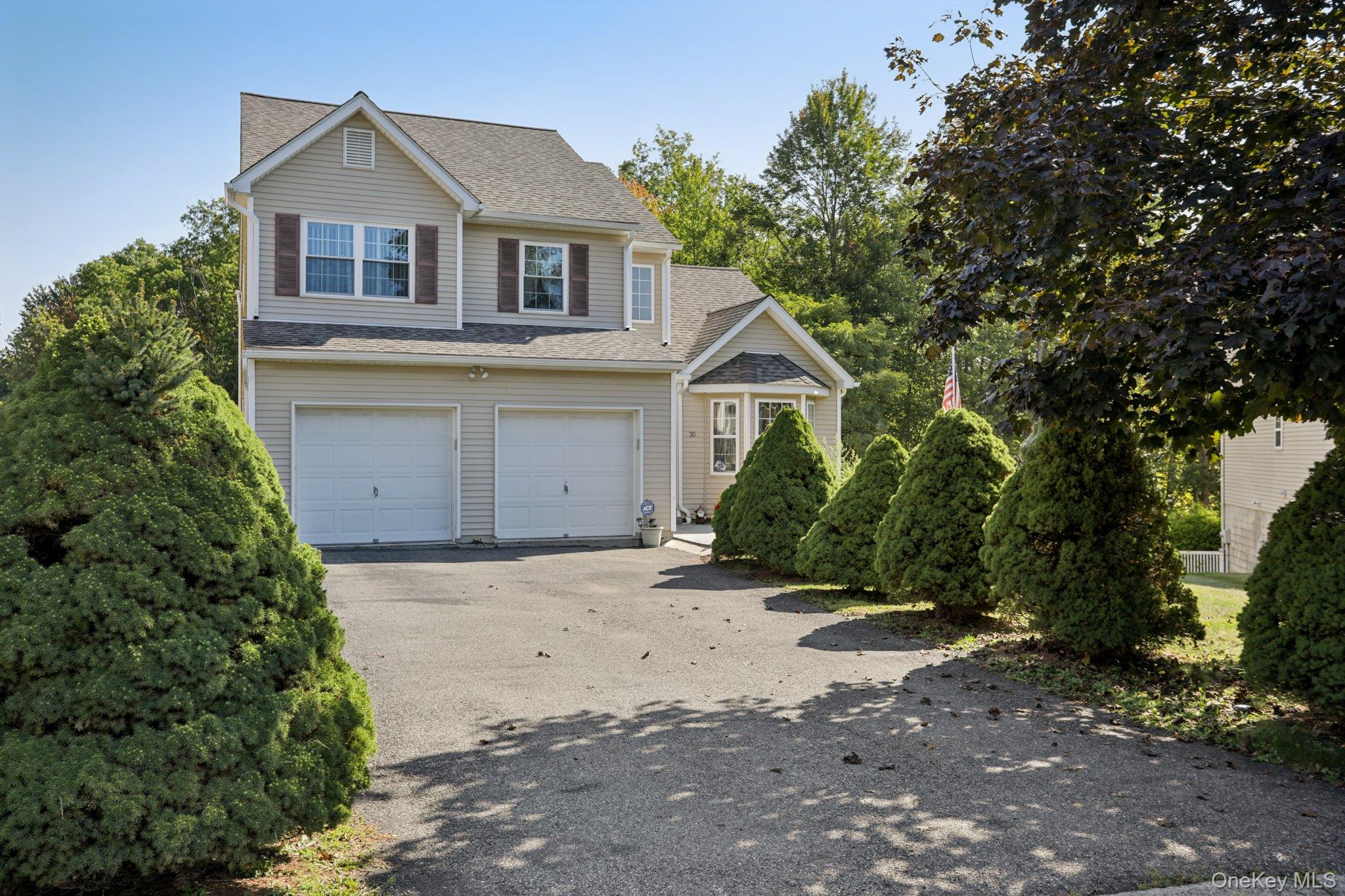 30 Reed Court Washingtonville, NY 10992 - Photo 32 of 36 a front view of a house with a yard and garage