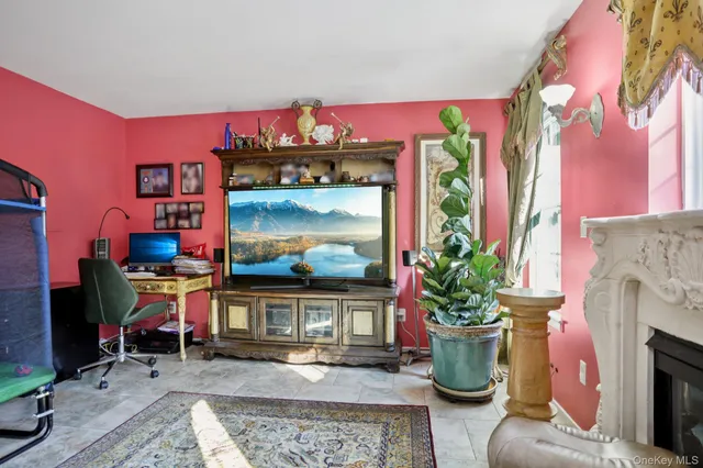 a living room with furniture a flat screen tv and a fireplace
