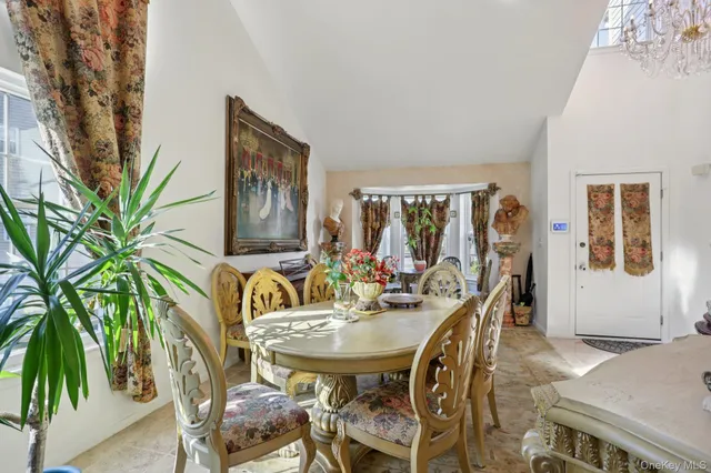 a view of a dining room with furniture and a potted plant