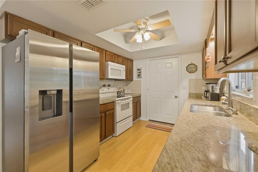 17577 Southeast 104th Circle Summerfield, FL 34491 - Photo 12 of 27 a kitchen with stainless steel appliances granite countertop a refrigerator and a stove top oven