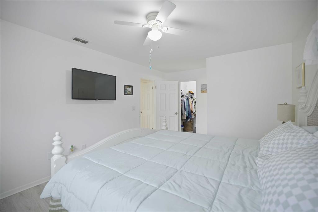 17577 Southeast 104th Circle Summerfield, FL 34491 - Photo 19 of 27 a bedroom with a bed and a flat screen tv