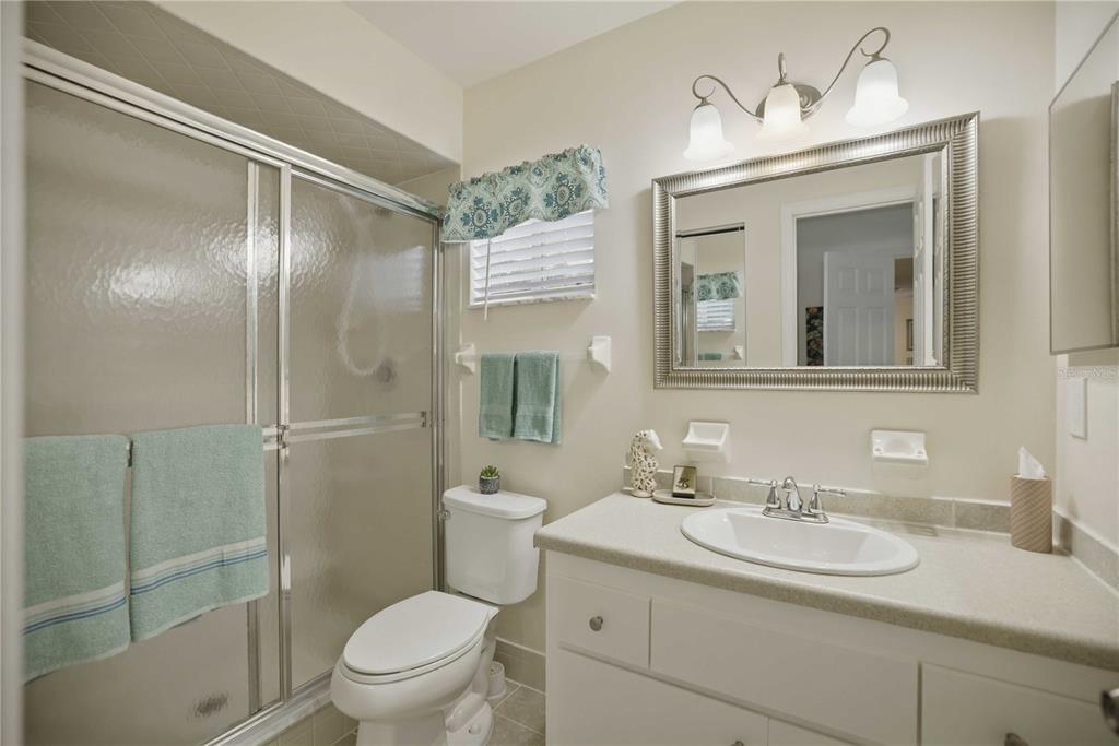 17577 Southeast 104th Circle Summerfield, FL 34491 - Photo 20 of 27 a bathroom with a granite countertop sink toilet and shower