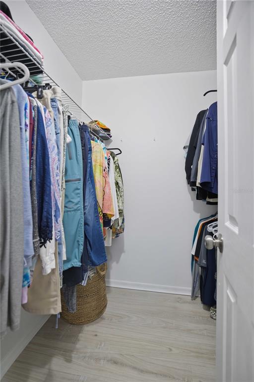17577 Southeast 104th Circle Summerfield, FL 34491 - Photo 21 of 27 a view of walk in closet with clothes and shoes