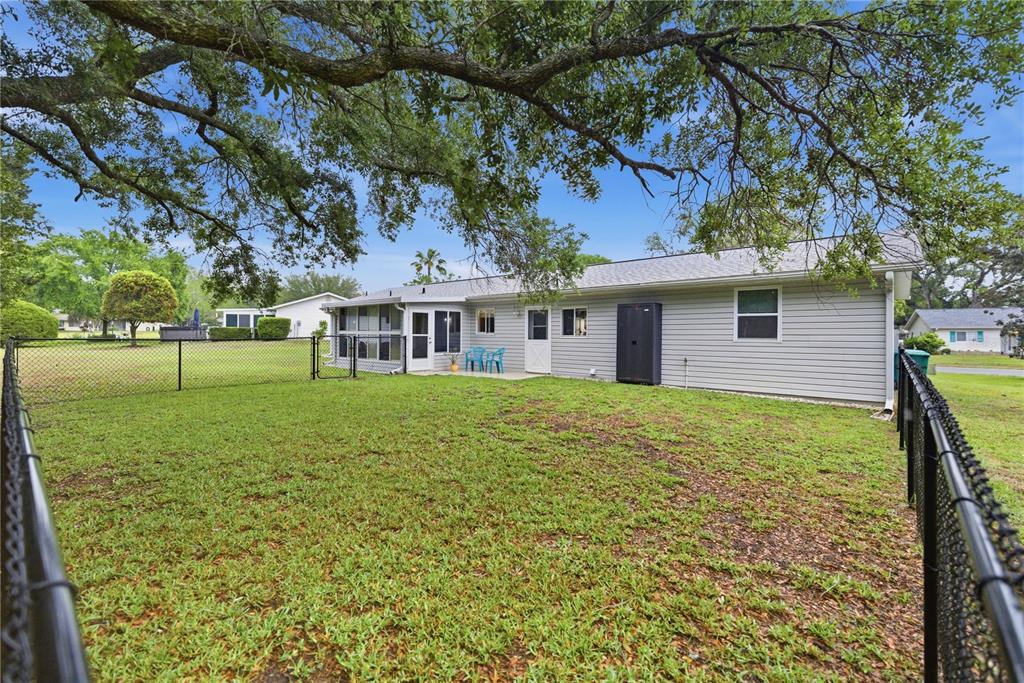 17577 Southeast 104th Circle Summerfield, FL 34491 - Photo 25 of 27 a front view of a house with a yard