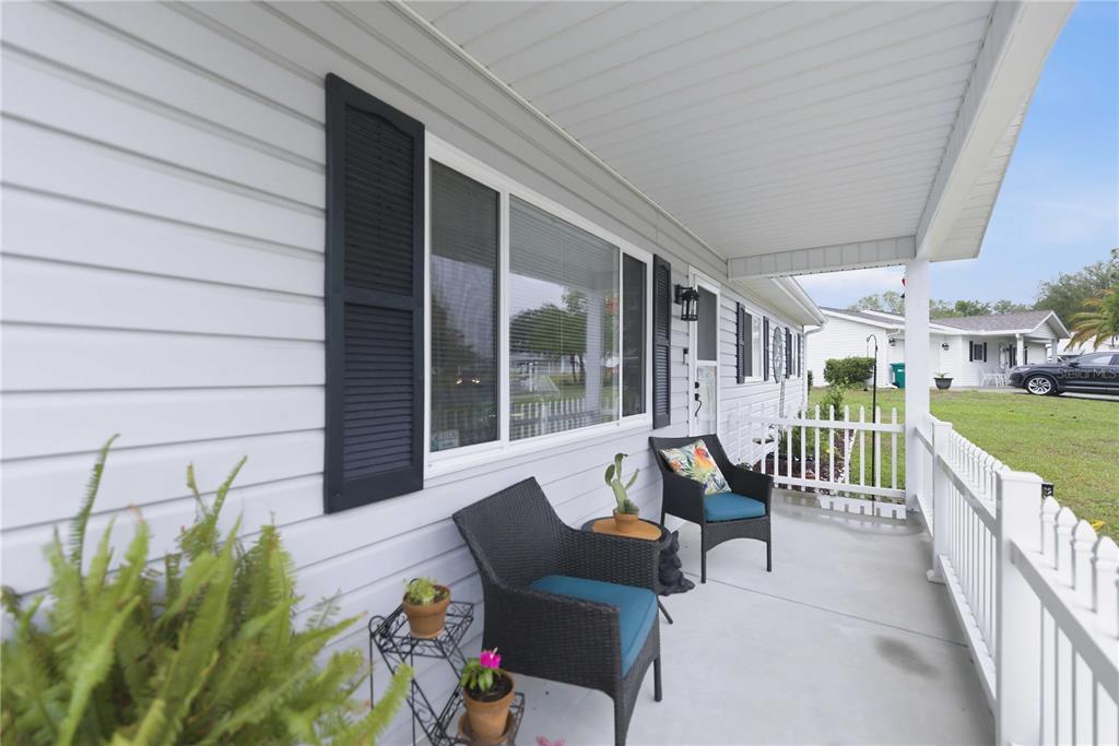 17577 Southeast 104th Circle Summerfield, FL 34491 - Photo 6 of 27 a view of a patio with couches table and chairs and potted plants