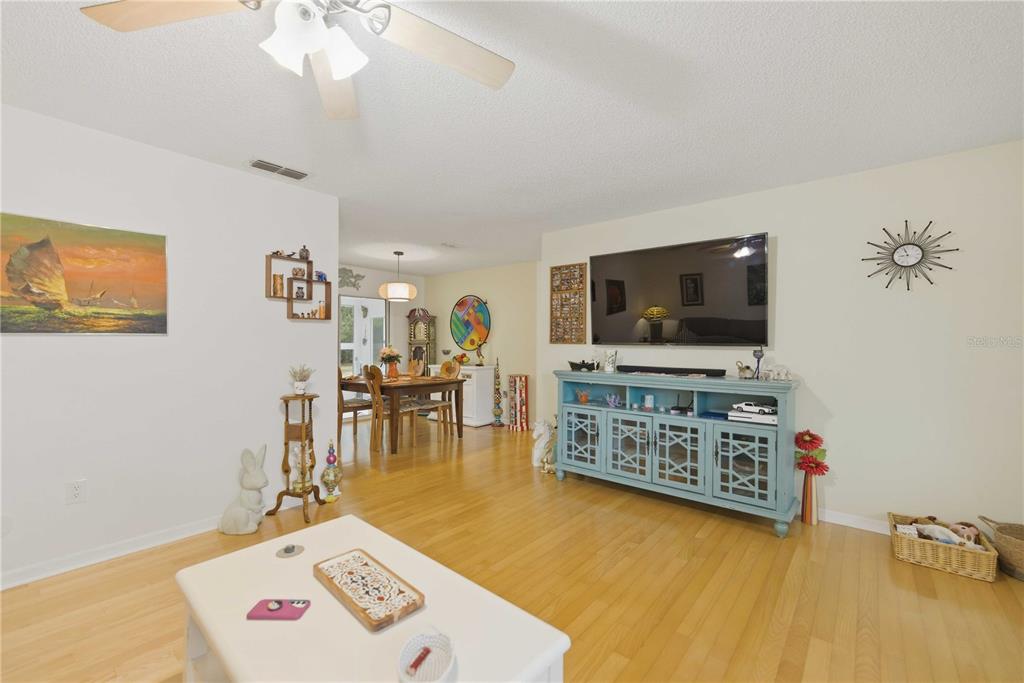 17577 Southeast 104th Circle Summerfield, FL 34491 - Photo 9 of 27 a living room with furniture and a flat screen tv