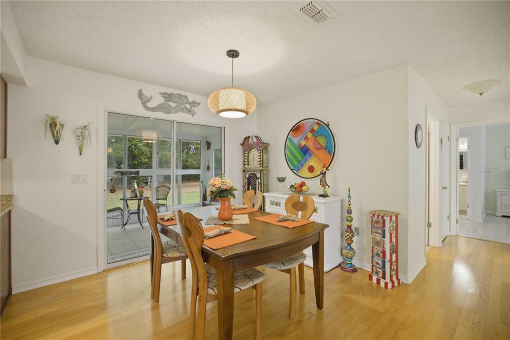17577 Southeast 104th Circle Summerfield, FL 34491 - Photo 10 of 27 a view of a dining room with furniture and wooden floor