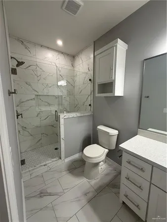 a bathroom with a toilet sink and shower