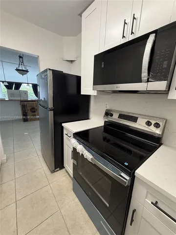 a kitchen with a stove and a microwave