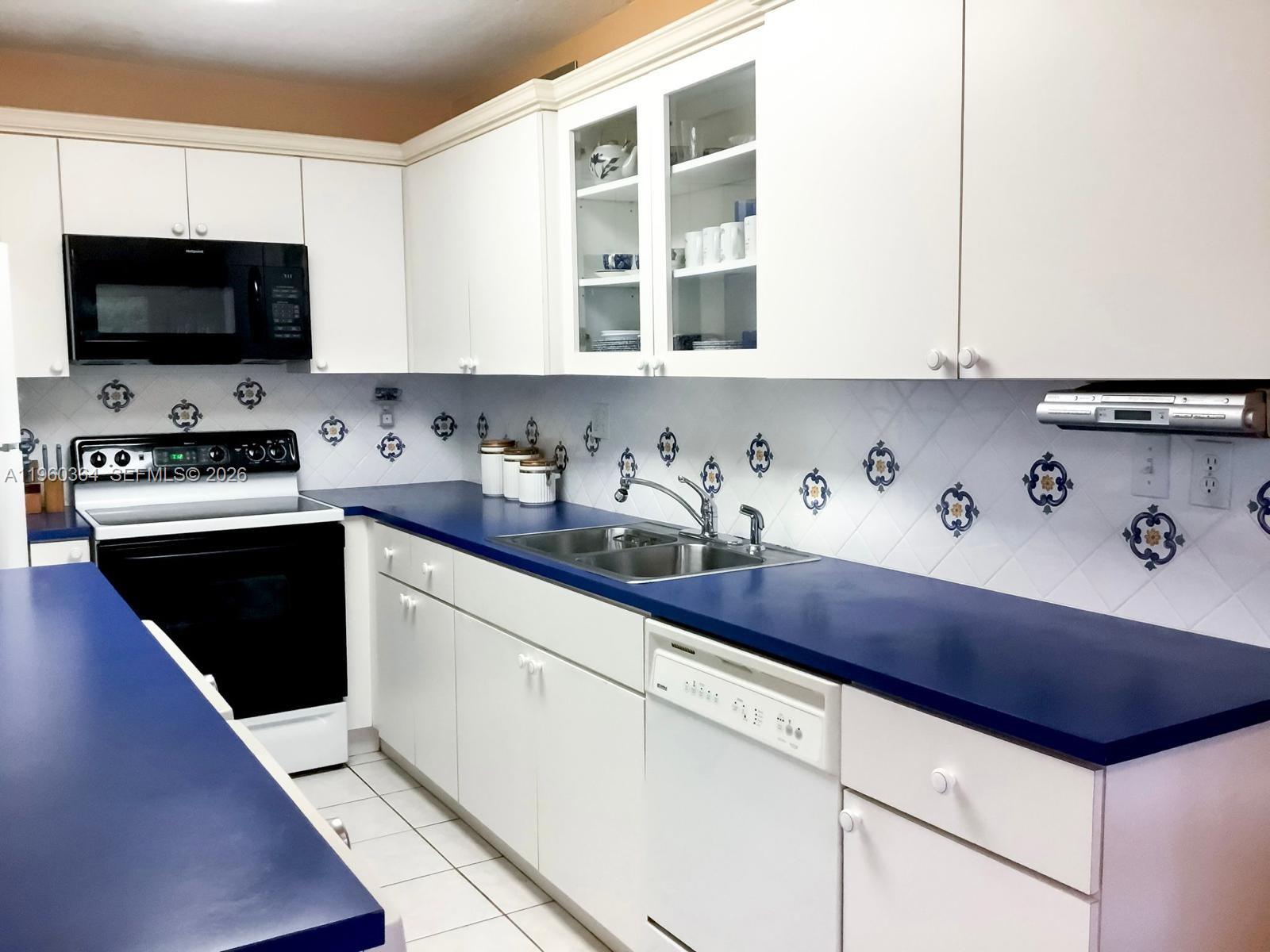 5800 Southwest 127th Avenue, Unit 2220 Miami, FL 33183 - Photo 1 of 36 a kitchen with stainless steel appliances granite countertop a sink and a stove