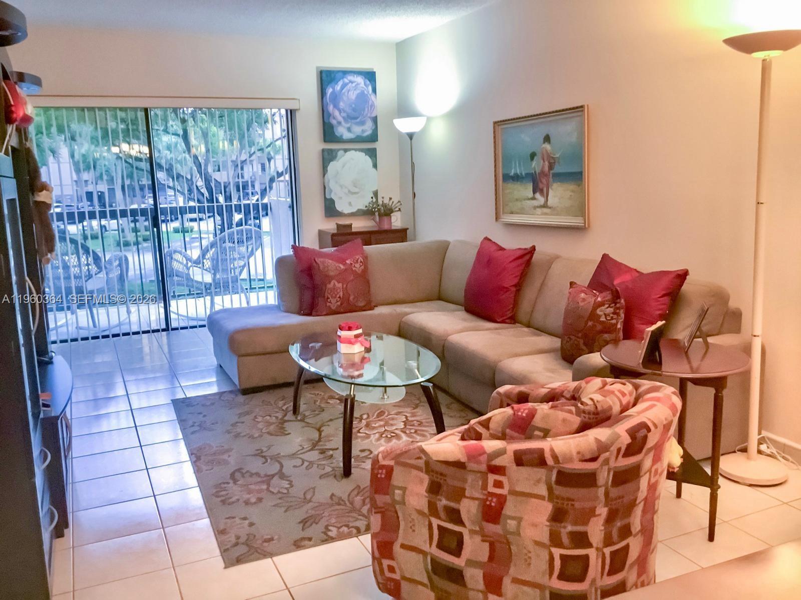 5800 Southwest 127th Avenue, Unit 2220 Miami, FL 33183 - Photo 2 of 36 a living room with furniture and a floor to ceiling window