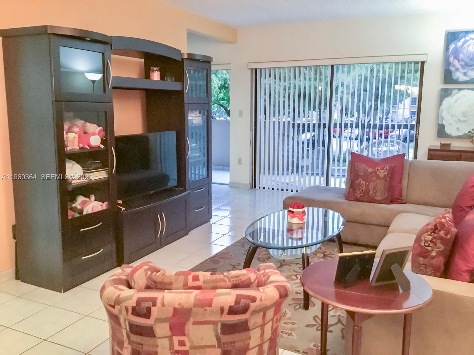5800 Southwest 127th Avenue, Unit 2220 Miami, FL 33183 - Photo 4 of 36 a living room with furniture and a flat screen tv