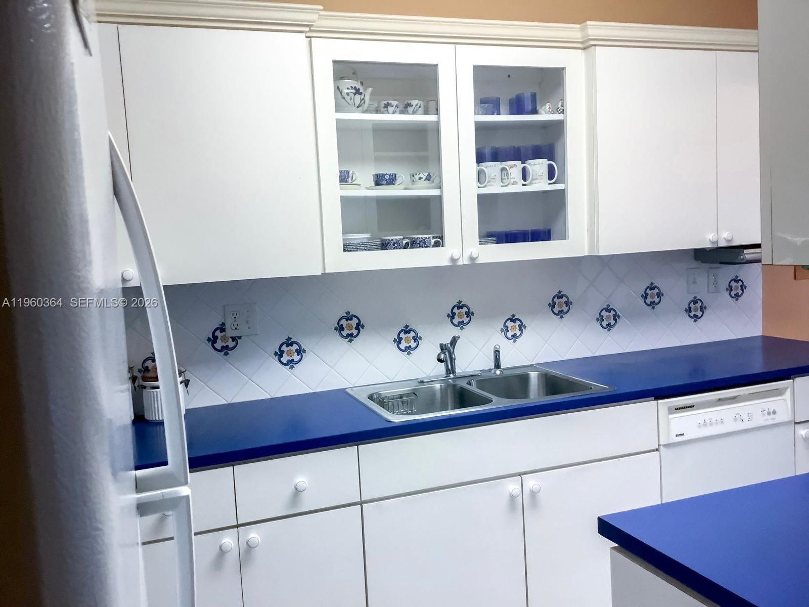 5800 Southwest 127th Avenue, Unit 2220 Miami, FL 33183 - Photo 5 of 36 a kitchen with a cabinets and window
