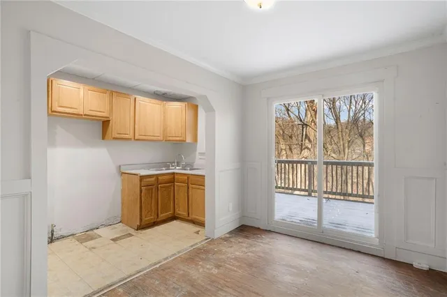 an empty room with fan and entrance