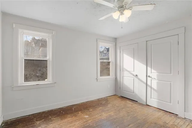 wooden floor in an empty room with a window