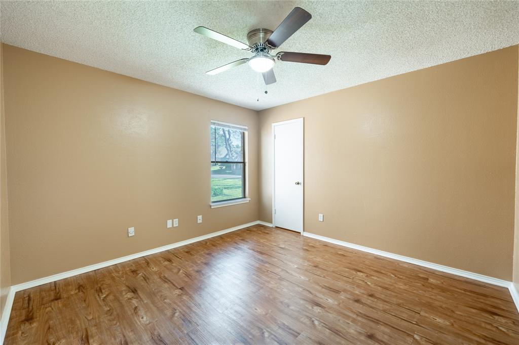 604 Windgate Court Arlington, TX 76012 - Photo 11 of 19 a view of an empty room with window and wooden floor
