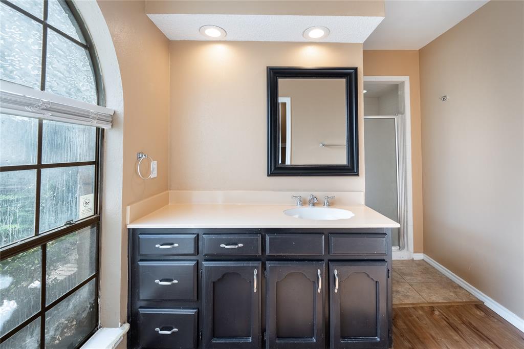 604 Windgate Court Arlington, TX 76012 - Photo 14 of 19 a bathroom with a sink and a mirror
