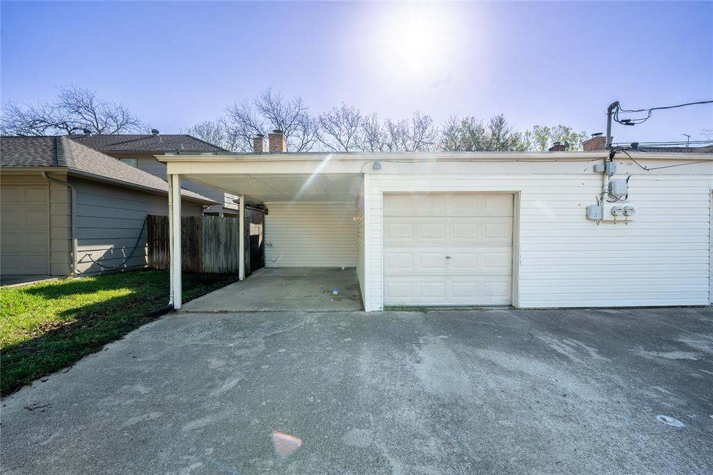 604 Windgate Court Arlington, TX 76012 - Photo 17 of 19 a view of a house with a yard and a garage