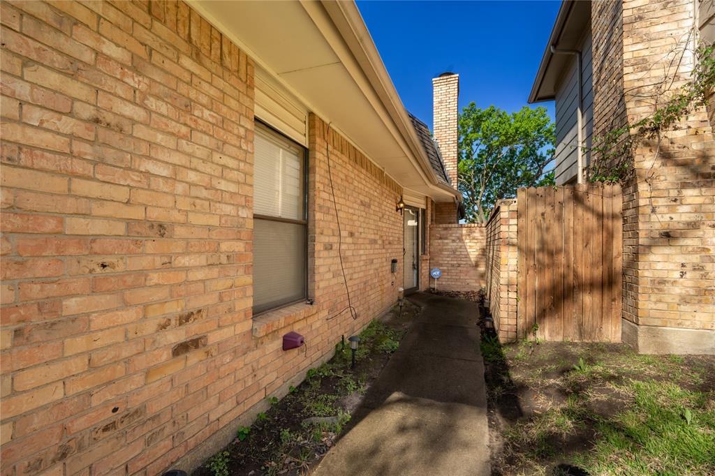 604 Windgate Court Arlington, TX 76012 - Photo 2 of 19 a pathway between two buildings